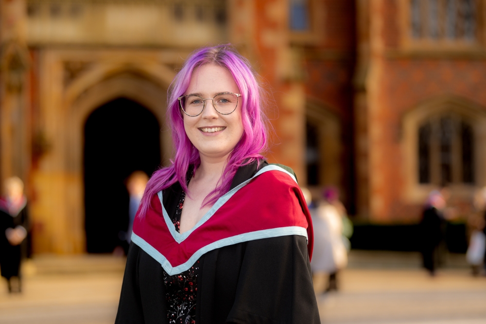 new female graduate with dyed pink hair smiling at Winter graduations 2023