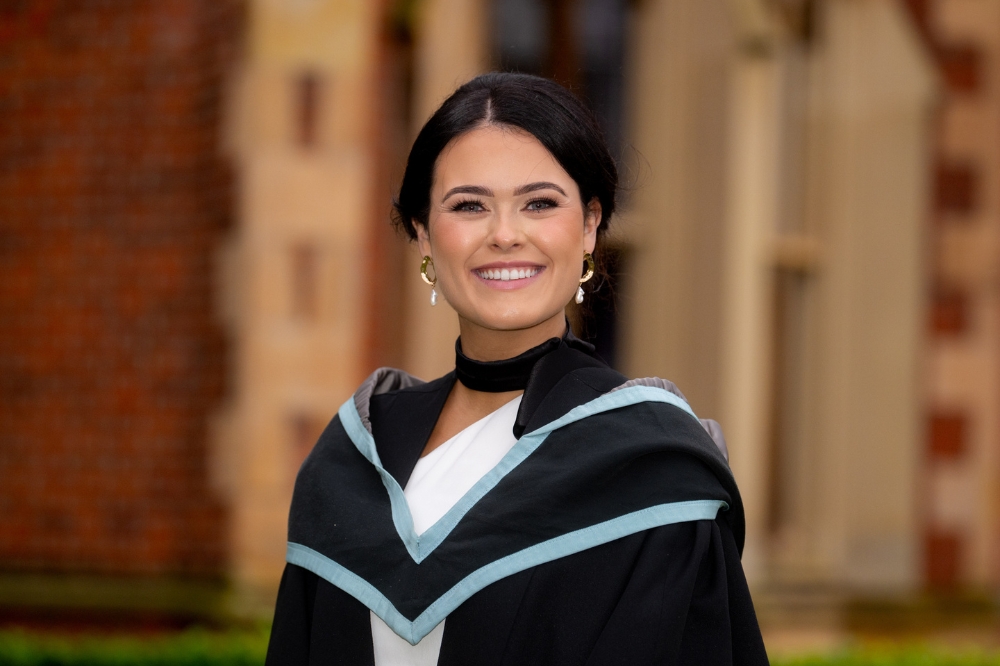 new female graduate smiling at Winter graduation 2023