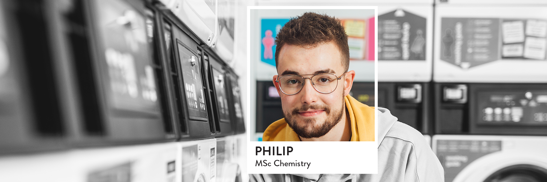 Image of student in Elms laundry room using the washing machine