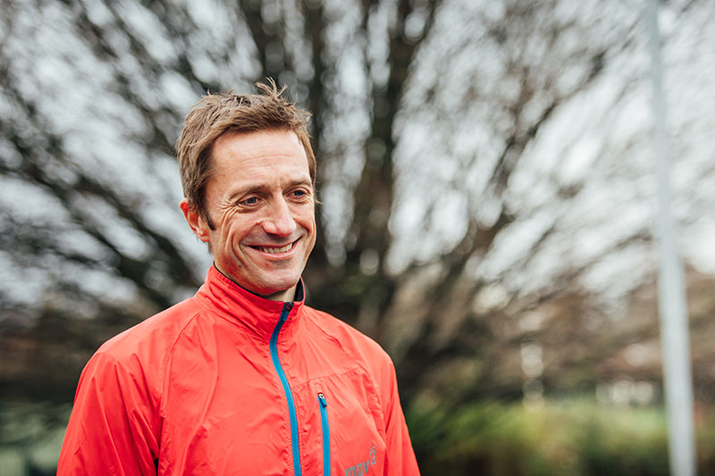 Image of Conor Curran in a bright running jacket