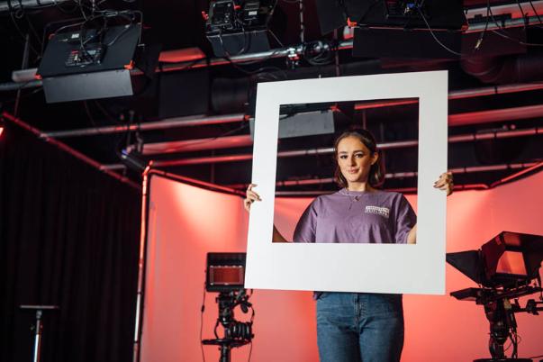 Image of Georgina holding up a polaroid cut out