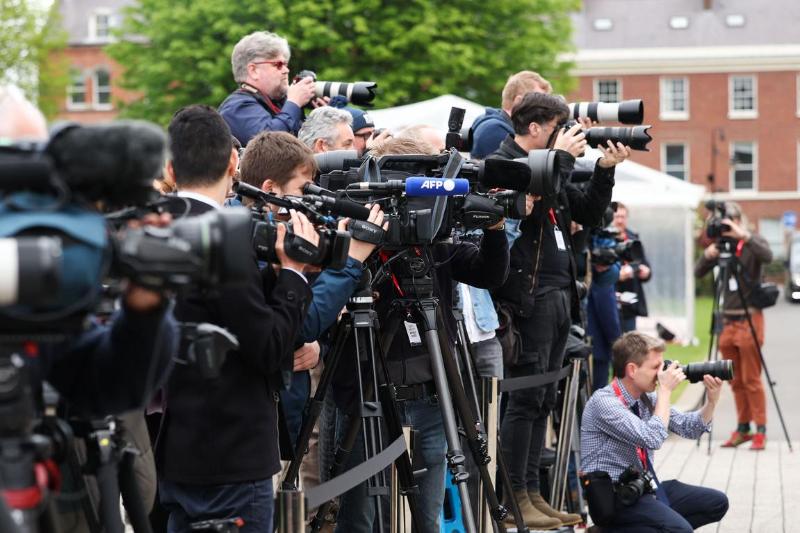 members of the press set up and photographing at the Agreement 25 conference, Queens University Belfast, 2023