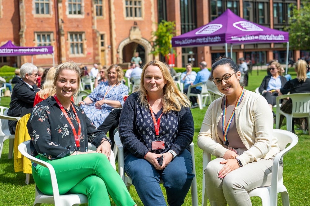 staff enjoying the sunshine and chat at the Great Big Purple Picnic in the quad during Mental Health Awareness Week 2023