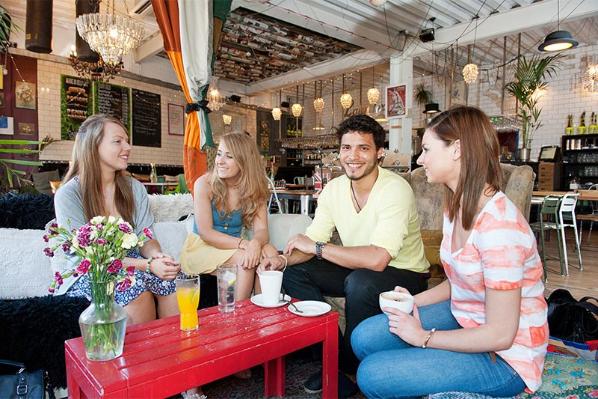 a group of students drinking coffee in a restaurant in Belfast