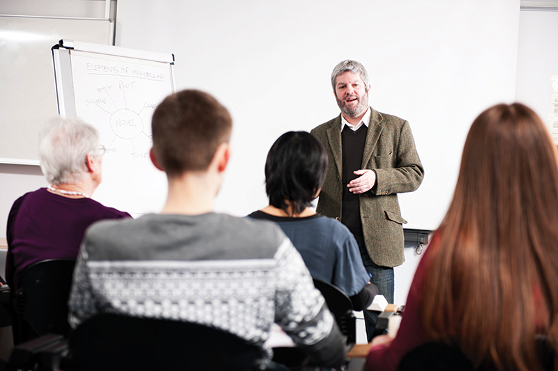 male teacher teaching a class