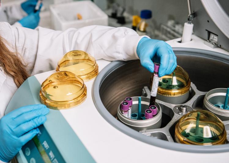 Researcher loading samples into a centrifuge