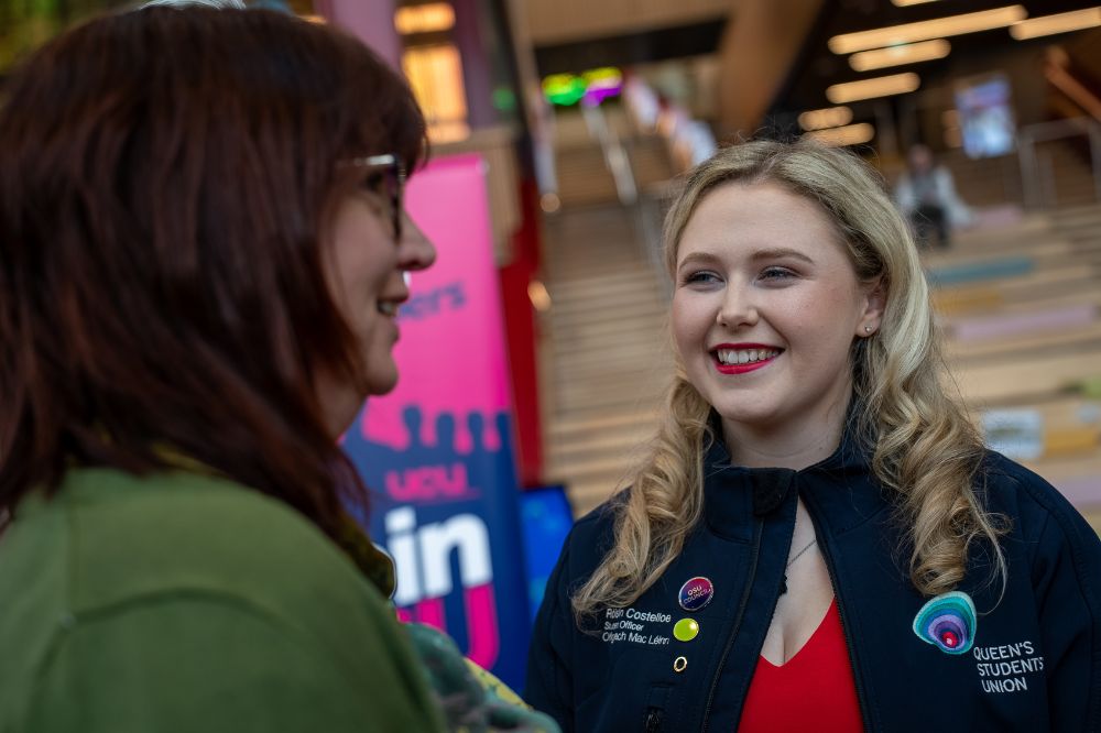 Two people smiling and chatting during the Green Dot awareness event in the Students’ Union.