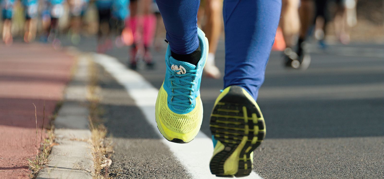 road-level shot showing feet of person running