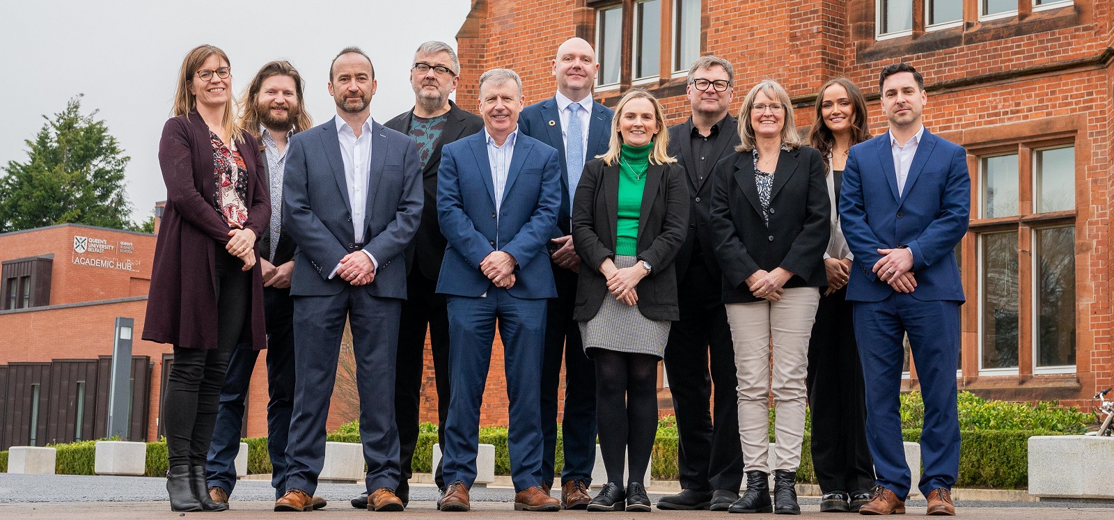 group of conference organisers / speakers / attendees and Queens staff members standing outside Riddel Hall at the first sustainability conference held at the University