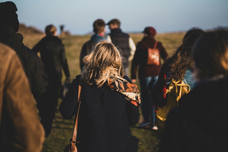 group of people out for a walk in the countryside in cool but sunny weather